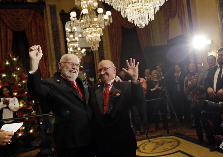 James Scales (left) and William Tasker celebrate their wedding at City Hall in Baltimore on Tuesday, Jan. 1, 2013. Same-sex couples in Maryland now are permitted to marry under a new law that went into effect after midnight on Tuesday. Maryland is the first state south of the Mason-Dixon Line to approve same-sex marriage. (AP Photo/Patrick Semansky)