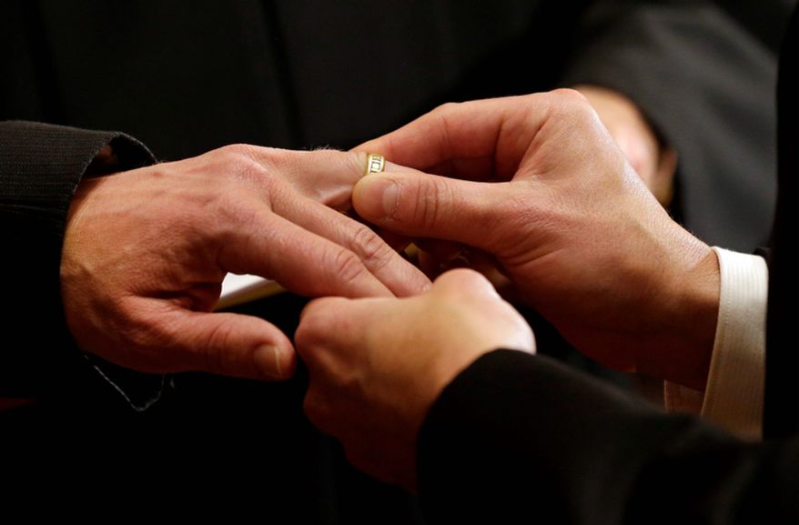 Thomas Rabe, right, places a wedding ring on Robert Coffman&#39;s finger during a marriage ceremony at City Hall in Baltimore, Tuesday, Jan. 1, 2013. (AP Photo/Patrick Semansky) ** FILE **