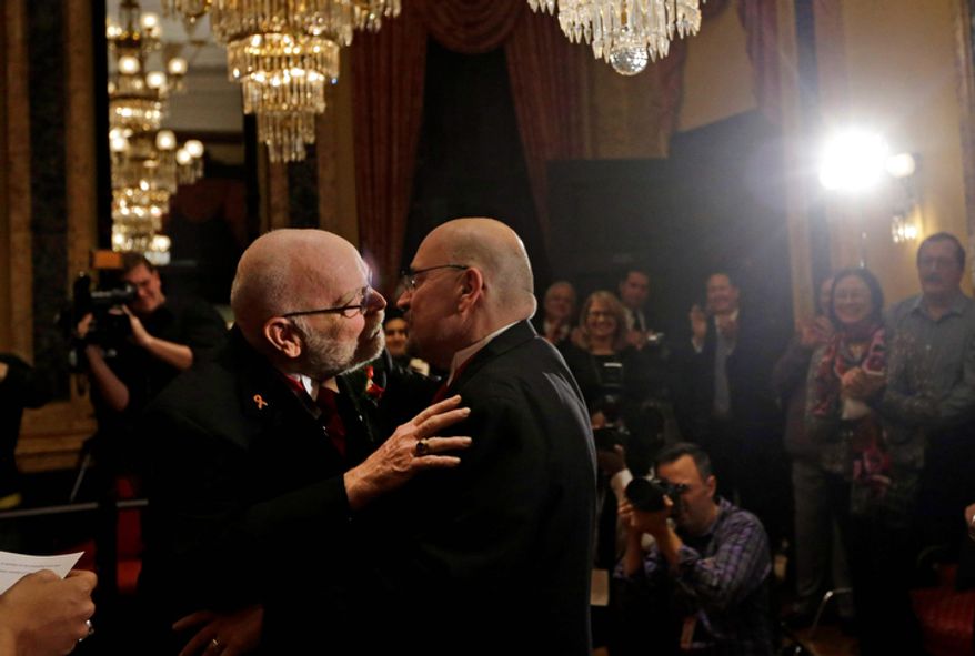 James Scales (left) and William Tasker kiss during their marriage ceremony at City Hall in Baltimore on Tuesday, Jan. 1, 2013. Same-sex couples in Maryland are now legally permitted to marry under a new law that went into effect after midnight on Tuesday. Maryland is the first state south of the Mason-Dixon Line to approve same-sex marriage. (AP Photo/Patrick Semansky)