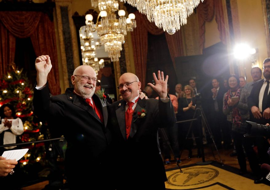 James Scales (left) and William Tasker react after their wedding ceremony at City Hall in Baltimore on Jan. 1, 2013. Same-sex couples in Maryland are now legally permitted to marry under a new law that went into effect after midnight on Jan. 1. Maryland is the first state south of the Mason-Dixon Line to approve same-sex marriage. (Associated Press)