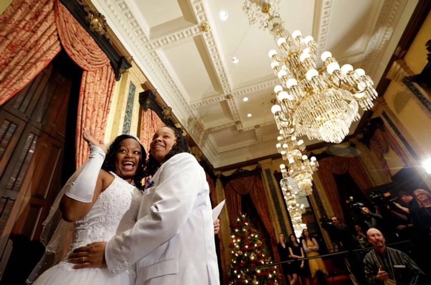 Darcia Anthony (left) and Danielle Williams hug after their wedding ceremony at City Hall in Baltimore on Tuesday, Jan. 1, 2013. Same-sex couples in Maryland are now legally permitted to marry under a new law that went into effect after midnight on Tuesday. Maryland is the first state south of the Mason-Dixon Line to approve same-sex marriage. (AP Photo/Patrick Semansky)