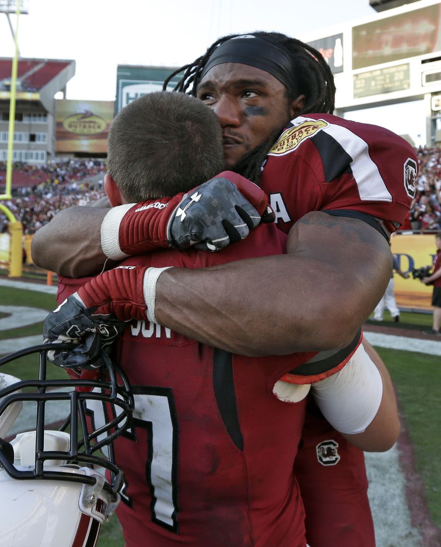 South Carolina running back Kenny Miles (31) celebrates with quarterback Dylan Thompson (17) after they defeated Michigan 33-28 in the Outback Bowl NCAA college football game, Tuesday, Jan. 1, 2013, in Tampa, Fla. (AP Photo/Chris O'Meara)