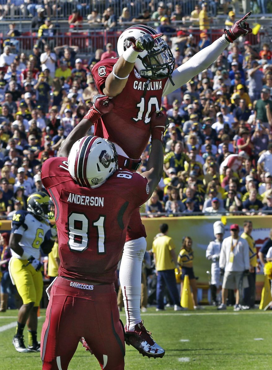 South Carolina wide receiver Damiere Byrd (10) celebrates with tight end Rory Anderson (81) after scoring on a 56-yard first-quarter touchdown against Michigan during the Outback Bowl NCAA college football game, Tuesday, Jan. 1, 2013, in Tampa, Fla. (AP Photo/Chris O'Meara)
