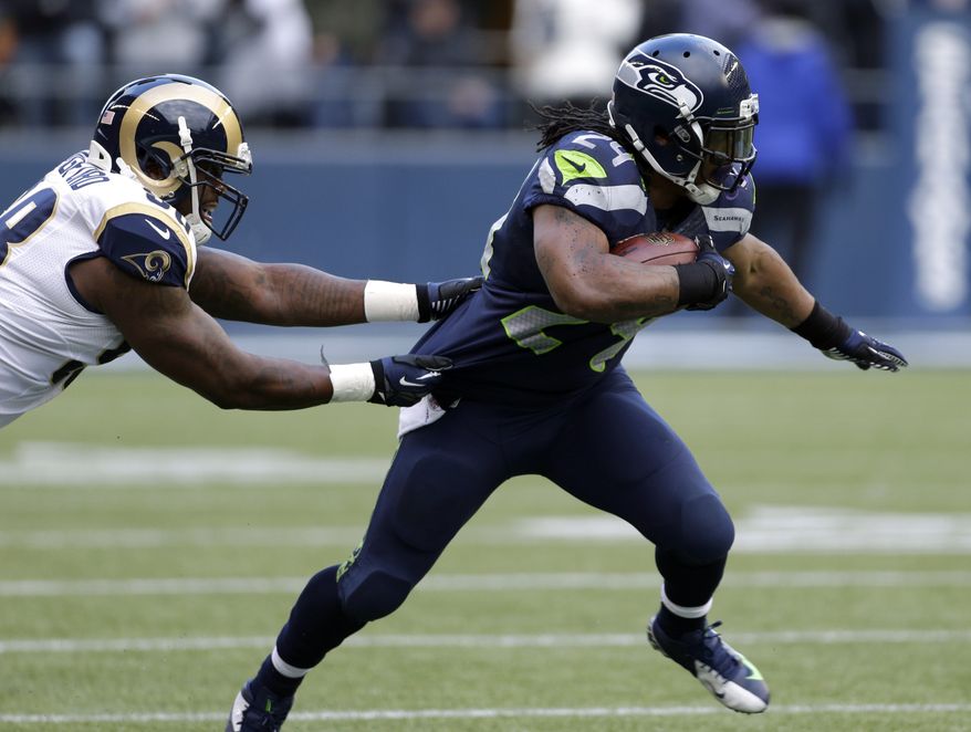 St. Louis Rams' Kendall Langford, left, chases Seattle Seahawks' Marshawn Lynch in the first half of an NFL football game, Sunday, Dec. 30, 2012, in Seattle. (AP Photo/Elaine Thompson)