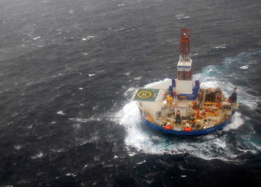 The mobile drilling unit Kulluk is towed by the tugs Aiviq and Nanuq in 29 mph winds and 20-foot seas 116 miles southwest of Kodiak, Alaska, on Sunday, Dec. 30, 2012. (AP Photo/U.S Coast Guard, Chris Usher)