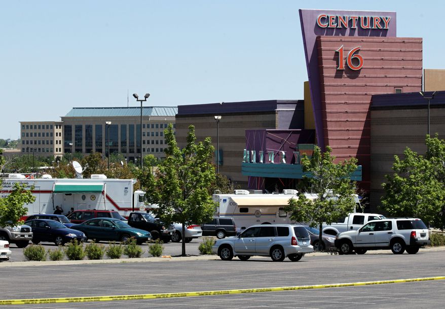** FILE ** Emergency vehicles remain at the Century 16 movie theater in Aurora, Colo., on July 21, 2012, after 12 people were fatally shot in the theater. (Associated Press)