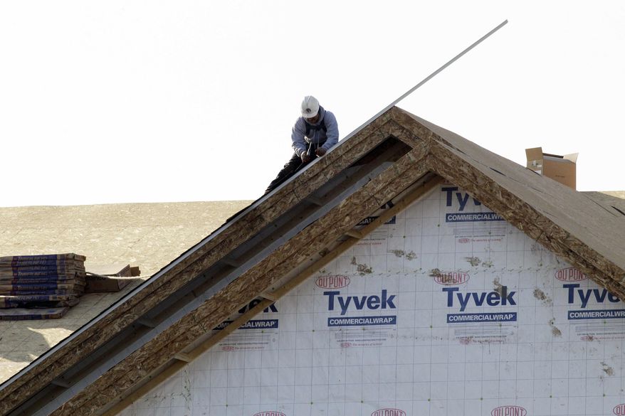** FILE ** In this Nov. 28, 2012, photo, a worker constructs a home in Chicago. (AP Photo/Nam Y. Huh)