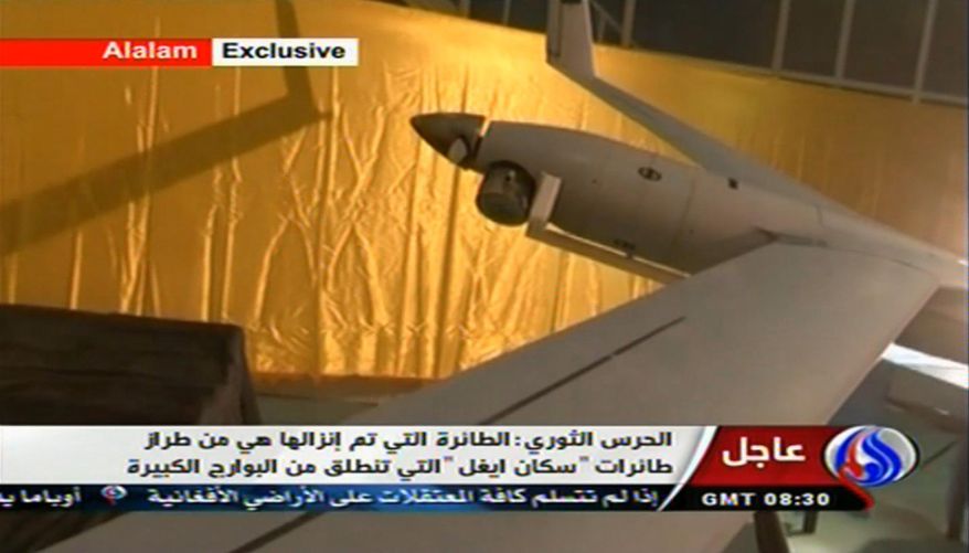 **FILE** This image taken from the Iranian state TV's Arabic-language channel Al-Alam, shows what is purported to be an intact ScanEagle drone aircraft in an exclusive broadcast on Dec. 4, 2012. Iran authorities claimed it had captured a U.S. drone after it entered Iranian airspace over the Persian Gulf and showed the image of a purportedly downed craft on state TV, but the U.S. Navy said all its unmanned aircraft in the region were "fully accounted for." (Associated Press/Al-Alam TV)