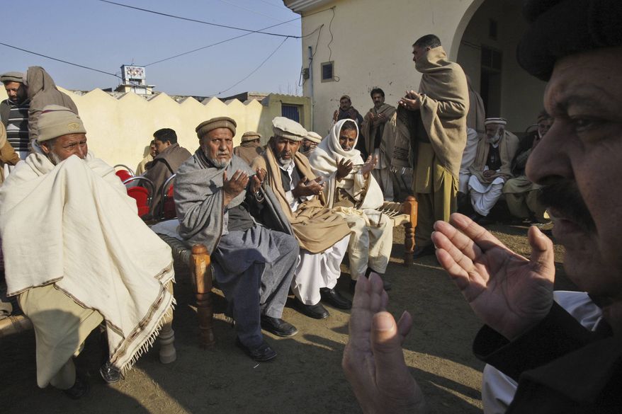 Pakistani men, chant prayers, during the funeral procession of aid worker Lubna Mahmoud, 26, who was killed on Tuesday, by gunmen, in Swabi, Pakistan, Wednesday, Jan. 2, 2013. (AP Photo/Mohammad Sajjad)