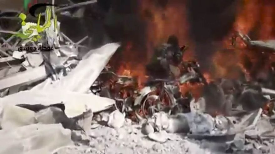 This citizen journalism image taken from video provided by Shaam News Network, which has been authenticated based on its contents and other AP reporting, shows a fire burning at the site of a Syrian government airstrike on a gas station in the eastern Damascus suburb of Mleiha, Syria, Wednesday, Jan. 2, 2013. Activists say dozens of people have been killed or wounded in an air raid on a gas station near the capital Damascus. (AP Photo/Shaam News Network via AP video)
