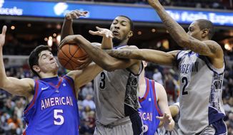 American guard Marko Vasic (5) battles for the ball against Georgetown forward Mikael Hopkins (3) and Greg Whittington (2) during the first half of an NCAA college basketball game, Saturday, Dec. 22, 2012, in Washington. (AP Photo/Nick Wass)