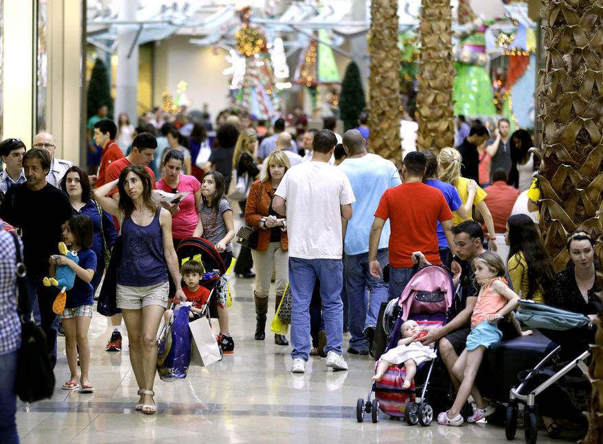Holiday shoppers make their way through the Mall at Millenia in Orlando, Fla., on Thursday, Dec. 20, 2012. (AP Photo/John Raoux)