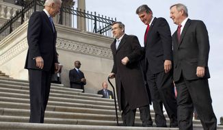 Vice President Joseph R. Biden watches at left as Sen. Mark Kirk, R-Ill., second from left, accompanied by Sen. Joe Manchin, D-W.Va., second form right, and Senate Majority whip Richard Durbin of Ill., right, walks the steps to the Senate door of the Capitol building on Capitol Hill in Washington, Thursday, Jan. 3, 2013. (AP Photo/ Evan Vucci)

