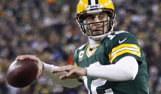 Green Bay Packers quarterback Aaron Rodgers looks to throw a pass during the first half of an NFL wild card playoff football game against the Minnesota Vikings Saturday, Jan. 5, 2013, in Green Bay, Wis. (AP Photo/Mike Roemer)