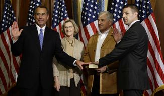 House Speaker John Boehner of Ohio performs a mock swearing in for Rep. Markwayne Mullin, R-Okla., Thursday, Jan. 3, 2013, on Capitol Hill in Washington as the 113th Congress began. (AP Photo/Charles Dharapak)