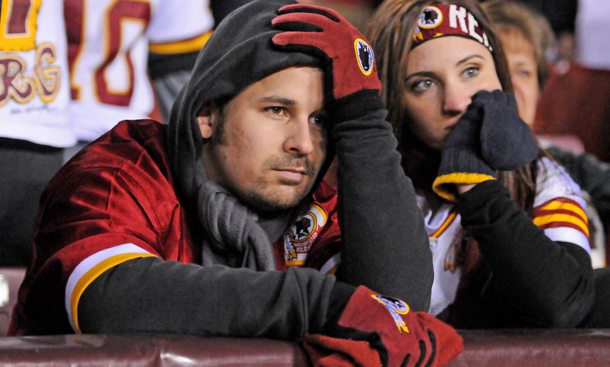 Preston Keres/Special to The Washington Times
Redskins fans sit dejectedly after a 24-14 loss in the NFC wild-card game, which had been made possible by a seven-game regular-season win streak.