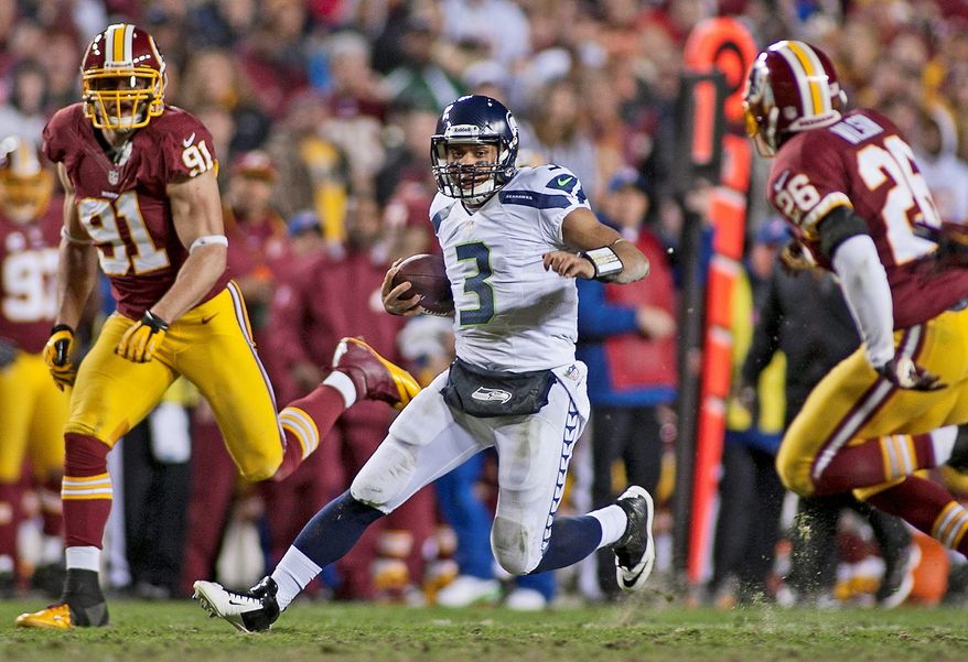 Seattle Seahawks quarterback Russell Wilson (3) runs for a first down in the second half against the Washington Redskins in the NFC wild card game at FedEx Field, Landover, Md., Sunday, January 6, 2013. (Craig Bisacre/The Washington Times)