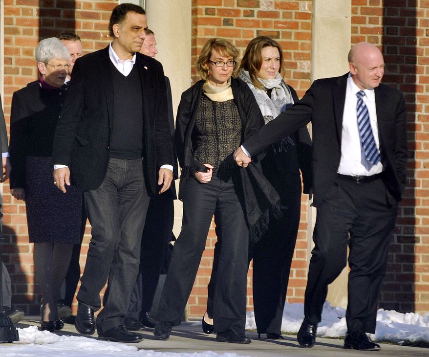 Former Rep. Gabrielle Giffords (third from right), holds hands with her husband, Mark Kelly (right), while leaving Town Hall at Fairfield Hills Campus in Newtown, Conn., after meeting with Newtown First Selectman Pat Llodra and other officials on Friday, Jan. 4, 2013. At far left is Connecticut Lt. Gov. Nancy Wyman; behind Mrs. Giffords to the left is Sen. Richard Blumenthal, Connecticut Democrat. Mrs. Giffords also met with families of the victims of the Sandy Hook Elementary School massacre that left 26 people dead. (AP Photo/The News-Times, Jason Rearick)
