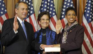 House Speaker John A. Boehner of Ohio, left, performs a mock swearing in for Rep. Donna Edwards, Maryland Democrat, Thursday, Jan. 3, 2013, on Capitol Hill in Washington as the 113th Congress began. (AP Photo/Cliff Owen)