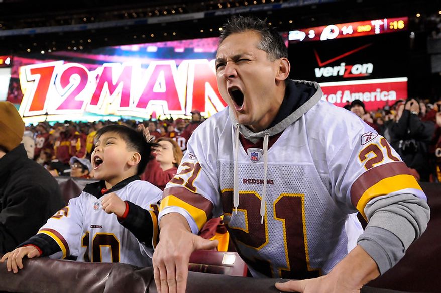 Auguste Remy and his son Dillon, 6, from Gaithersburg, Md., scream while the Redskins are on defense in the NFC wild card game at FedEx Field, Landover, Md., Jan. 6, 2013. (Preston Keres/Special to The Washington Times)