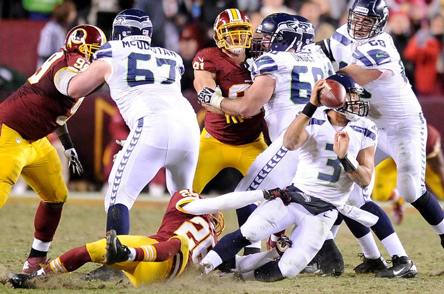 Seattle Seahawks quarterback Russell Wilson (3) is sacked by Washington Redskins cornerback Josh Wilson (26) in the third quarter of the NFC wild card game at FedEx Field, Landover, Md., Jan. 6, 2013. (Preston Keres/Special to The Washington Times)