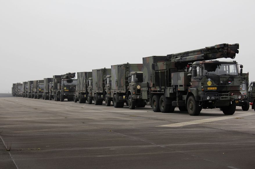 A camouflage convoy of Dutch military trucks carrying two batteries of Patriot missiles is lined up for a media opportunity before departing from De Peel Air Base in Vreedepeel, Netherlands, on Monday, Jan. 7, 2013. Twelve Patriot missile launching systems from the Dutch military are on their way to help Turkey defend its border against Syrian rockets. The missile batteries are scheduled to be fully operational by Jan. 26. (AP Photo/Mark D. Carlson)
