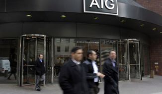 People pass the AIG building, in New York, Tuesday, Jan. 8, 2013. American International Group Inc. said Tuesday its board of directors will weigh whether to take part in a shareholder lawsuit against the U.S. over the government&#x27;s $182 billion bailout of the insurer. (AP Photo/Richard Drew)