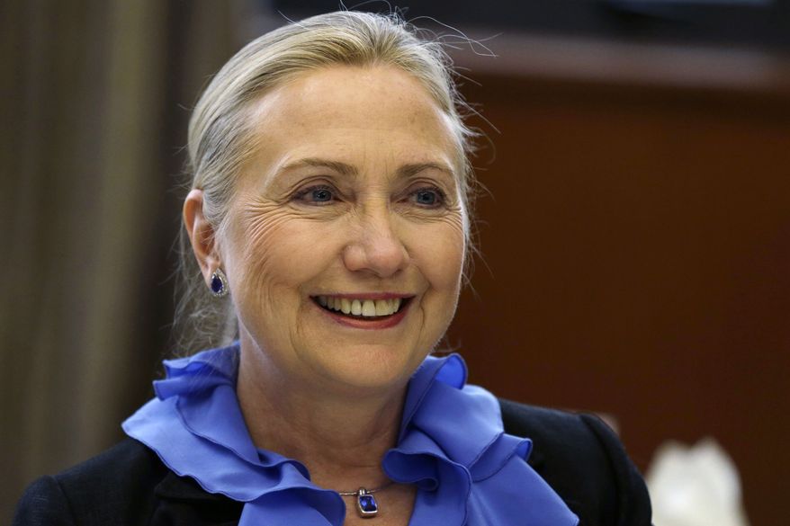 ** FILE ** In this Nov. 16, 2012, file photo, U.S. Secretary of State Hillary Rodham Clinton poses for photographs before dinner at the Ministry of Foreign Affairs in Singapore. (AP Photo/Matt Rourke, File)