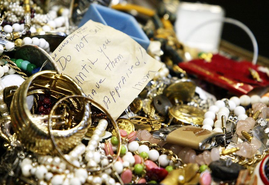 Costume jewelry was among the mass of stolen goods from at least 24 burglaries in rural New York. In an attempt to find the owners of the 30,000 items seized, police displayed them Wednesday night at a high school. (Associated Press)
