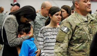 South Carolina Gov. Nikki Haley comforts her 10-year-old son, Nalin, and 14-year-old daughter, Rena, at a National Guard site outside Columbia where her husband, Michael, was preparing to depart with a Guard unit. Capt. Michael Haley will take part in a month of training before his deployment to Afghanistan to work with locals to improve farming practices. (Associated Press)