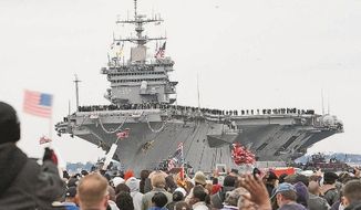 ** FILE ** Family members and friends in Norfolk, Va., welcome home the USS Enterprise after its 25th and final deployment, along with the 5,500 sailors and Marines who spent nearly eight months at sea. The Enterprise is the world&#x27;s first nuclear-powered aircraft carrier. (Associated Press)