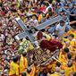 Catholic devotees jostle near the centuries-old image of the Black Nazarene on its feast day Wednesday in Manila. The Catholic Church no longer sways the masses on issues such as birth control as it once did. (Associated Press)