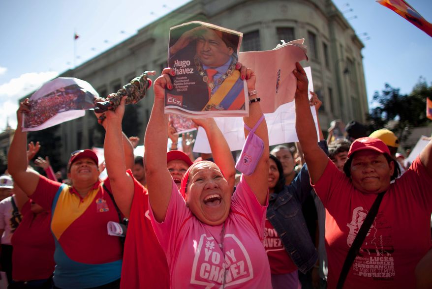 Supporters of Venezuela's President Hugo Chavez chant slogans outside the presidential palace in Caracas on Thursday, what was supposed to be his inauguration day. At the alternative rally, they show their support for the ailing leader by wearing T-shirts with the slogan "I am Chavez." The swearing-in ceremony has been indefinitely delayed. (Associated Press)