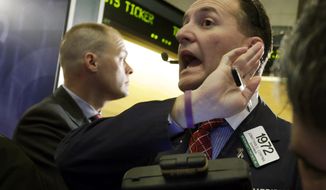 Trader Jonathan Corpina (right) works on the floor of the New York Stock Exchange on Jan. 10, 2013. (Associated Press)