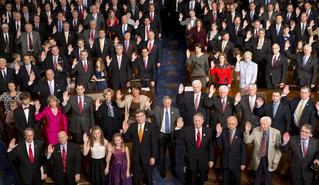 Members of the 113th Congress, many accompanied by family members, take the oath of office in the House of Representatives chamber at the U.S. Capitol in Washington on Thursday, Jan. 3, 2013. (AP Photo/J. Scott Applewhite)