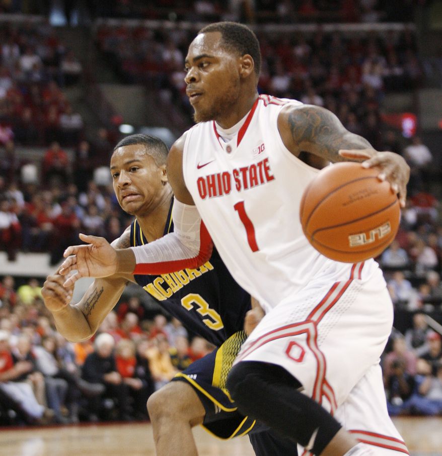 Ohio State's DeShaun Thomas (1) drives as Michigan's Trey Burke (3) tries to keep up during the first half of an NCAA college basketball game Sunday, Jan. 13, 2013 in Columbus, Ohio. Ohio State won 56-53. (AP Photo/Mike Munden)