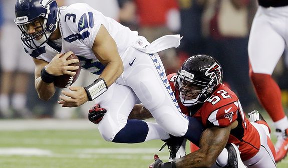 Seattle Seahawks quarterback Russell Wilson (3) is tackled by Atlanta Falcons&#39; Akeem Dent (52) during the first half of an NFC divisional playoff NFL football game Sunday, Jan. 13, 2013, in Atlanta. (AP Photo/David Goldman)