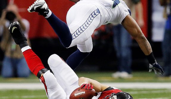 Atlanta Falcons tight end Tony Gonzalez (88) makes the catch under Seattle Seahawks middle linebacker Bobby Wagner (54) during the second half of an NFC divisional playoff NFL football game Sunday, Jan. 13, 2013, in Atlanta. (AP Photo/John Bazemore)