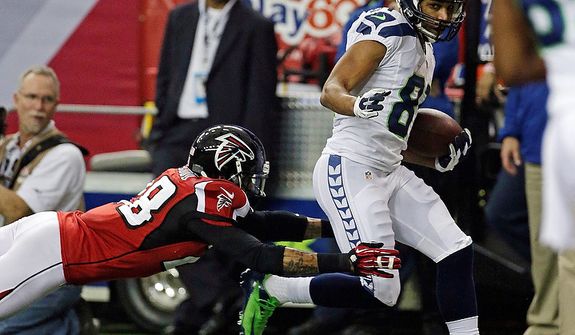 Seattle Seahawks wide receiver Golden Tate catches a touchdown pass in front of Atlanta Falcons free safety Thomas DeCoud (28)  during the second half of an NFC divisional playoff NFL football game Sunday, Jan. 13, 2013, in Atlanta. (AP Photo/Dave Martin)