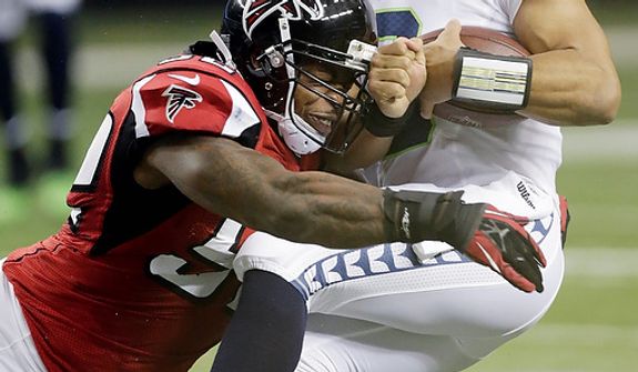 Seattle Seahawks quarterback Russell Wilson (3) is sacked by Atlanta Falcons middle linebacker Akeem Dent (52) during the first half of an NFC divisional playoff NFL football game Sunday, Jan. 13, 2013, in Atlanta. (AP Photo/Dave Martin)