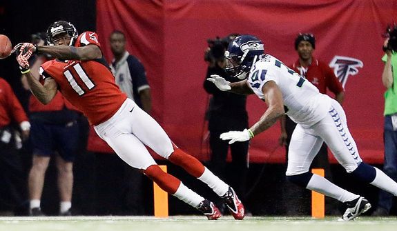 Atlanta Falcons wide receiver Julio Jones (11) works against Seattle Seahawks DeShawn Shead (35) during the second half of an NFC divisional playoff NFL football game Sunday, Jan. 13, 2013, in Atlanta. (AP Photo/David Goldman)