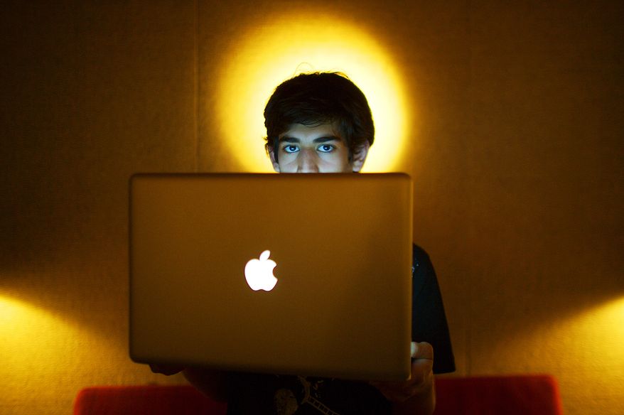 ** FILE ** Internet activist Aaron Swartz poses for a photo in Miami Beach, Fla., in 2009. He was found dead on Friday, Jan. 11, in his apartment in the Brooklyn borough of New York. On Saturday, Jan. 26, the hacker group Anonymous attacked a Justice Department website, claiming that an unjustified investigation by the federal government prompted him to commit suicide. (AP Photo/The New York Times, Michael Francis McElroy)