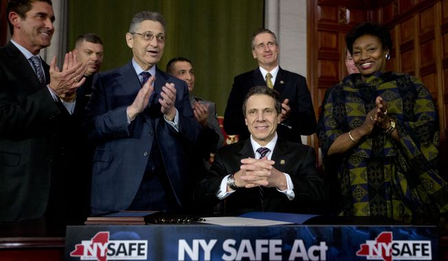 ** FILE ** New York Gov. Andrew Cuomo and legislative leaders applaud after Cuomo signed New York&#x27;s Secure Ammunition and Firearms Enforcement Act into law during a ceremony in the Red Room at the Capitol on Jan. 15, 2013, in Albany, N.Y. From left are Senate co-leader Jeffrey Klein, Bronx Democrat, Assembly Speaker Sheldon Silver, Manhattan Democrat, Lt. Gov. Robert Duffy (behind Cuomo) and Senate Democratic Leader Andrea Stewart-Cousins, Yonkers Democrat. (Associated Press)