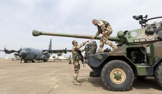 Legionnaires of France&#x27;s 1st Foreign Cavalry Regiment, based in Orange, France, deploy at the airport in Bamako, Mali. An official at France&#x27;s Defense Ministry says the country will &quot;gradually deploy&quot; a total of 2,500 troops to Mali, and the French president says the military operation will last until security has been restored and African forces are ready to take charge. (AP Photo/Arnaud Roine, French Army Communications Audiovisual Office [ECPAD])