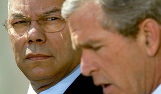 Secretary of State Colin Powell looks April 4, 2002, on as President Bush makes a statement in the Rose Garden of the White House. (Associated Press) **FILE** 