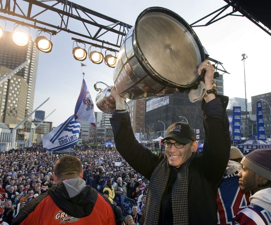 FILE - In this Dec. 2, 2009 file photo, Montreal Alouettes head coach Marc Trestman holds up the Grey Cup for fans during the victory parade in Montreal. The Bears have hired Trestman to replace the fired Lovie Smith, hoping he can get the most out of quarterback Jay Cutler and make Chicago a playoff team on a consistent basis. (AP Photo/The Canadian Press, Ryan Remiorz, File)