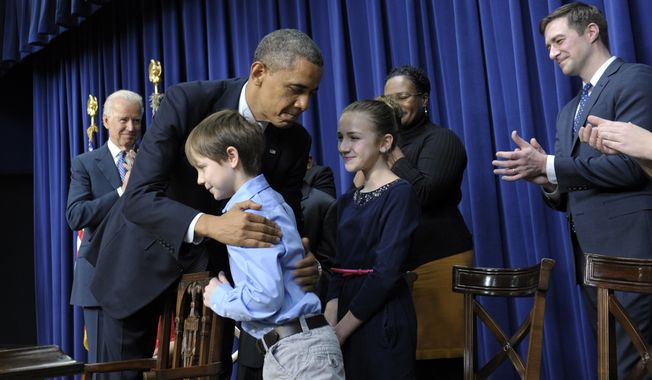President Obama, accompanied by Vice President Joseph R. Biden (left), hugs 8-year-old letter writer Grant Fritz during a news conference on proposals to reduce gun violence on Wednesday, Jan. 16, 2013, in the South Court Auditorium at the White House complex in Washington. Mr. Obama and Mr. Biden were joined by law enforcement officials, lawmakers and children who wrote the president about gun violence following the shooting at an elementary school in Newtown, Conn., last month. (AP Photo/Susan Walsh)

