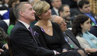 Lynn and Chris McDonnell, parents of Grace McDonnell, who was killed in the Newtown, Conn., school shooting, listen as President Obama talks about their daughter during a Jan. 16, 2013, news conference at the White House on proposals to reduce gun violence. (Associated Press)