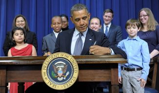 President Obama signed executive orders in the presence of children who wrote to him about gun violence. Among them were (from left) Hinna Zeejah, 8, and Nadia Zeejah, Hinna&#39;s mother; Taejah Goode, 10, and Kimberly Graves, Taejah&#39;s mother; Julia Stokes, 11, and Theophil Stokes, Julia&#39;s father; and Grant Fritz, 8, and Elisabeth Carlin, Grant&#39;s mother. (Associated Press)