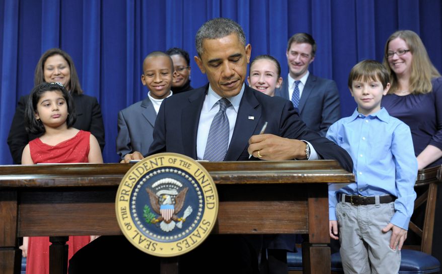 President Obama signed executive orders in the presence of children who wrote to him about gun violence. Among them were (from left) Hinna Zeejah, 8, and Nadia Zeejah, Hinna's mother; Taejah Goode, 10, and Kimberly Graves, Taejah's mother; Julia Stokes, 11, and Theophil Stokes, Julia's father; and Grant Fritz, 8, and Elisabeth Carlin, Grant's mother. (Associated Press)